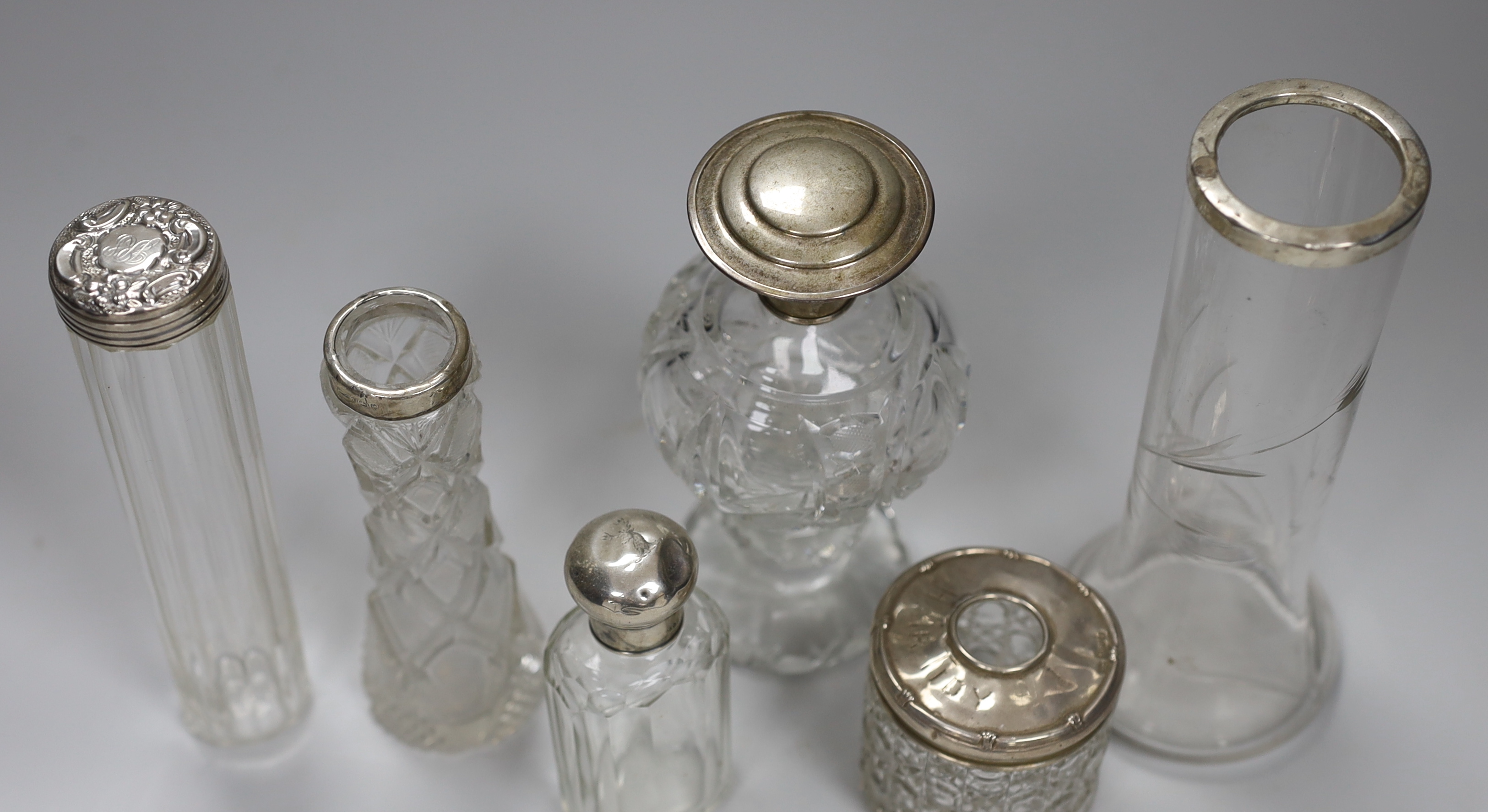 Two silver rimmed cut glass vases, a sterling mounted cut glass scent bottle and three assorted toilet jars